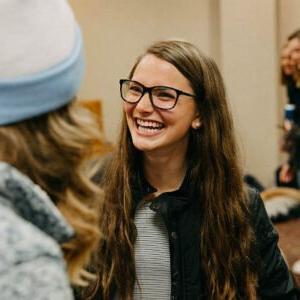 A smiling female student at a campus event.